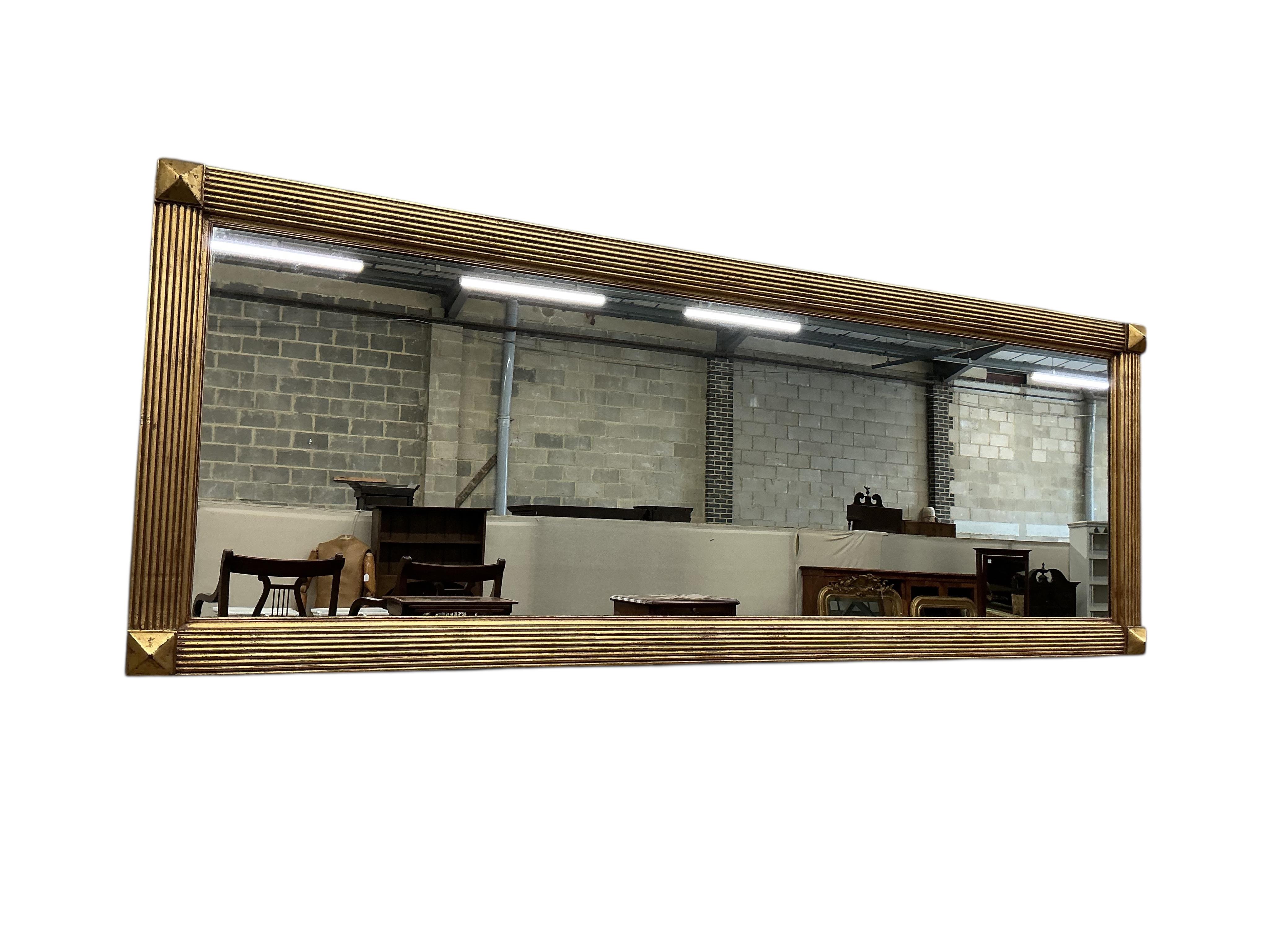 A reproduction gilt composition glass top console table, width 138cm, depth 46cm, height 78cm and a mirror